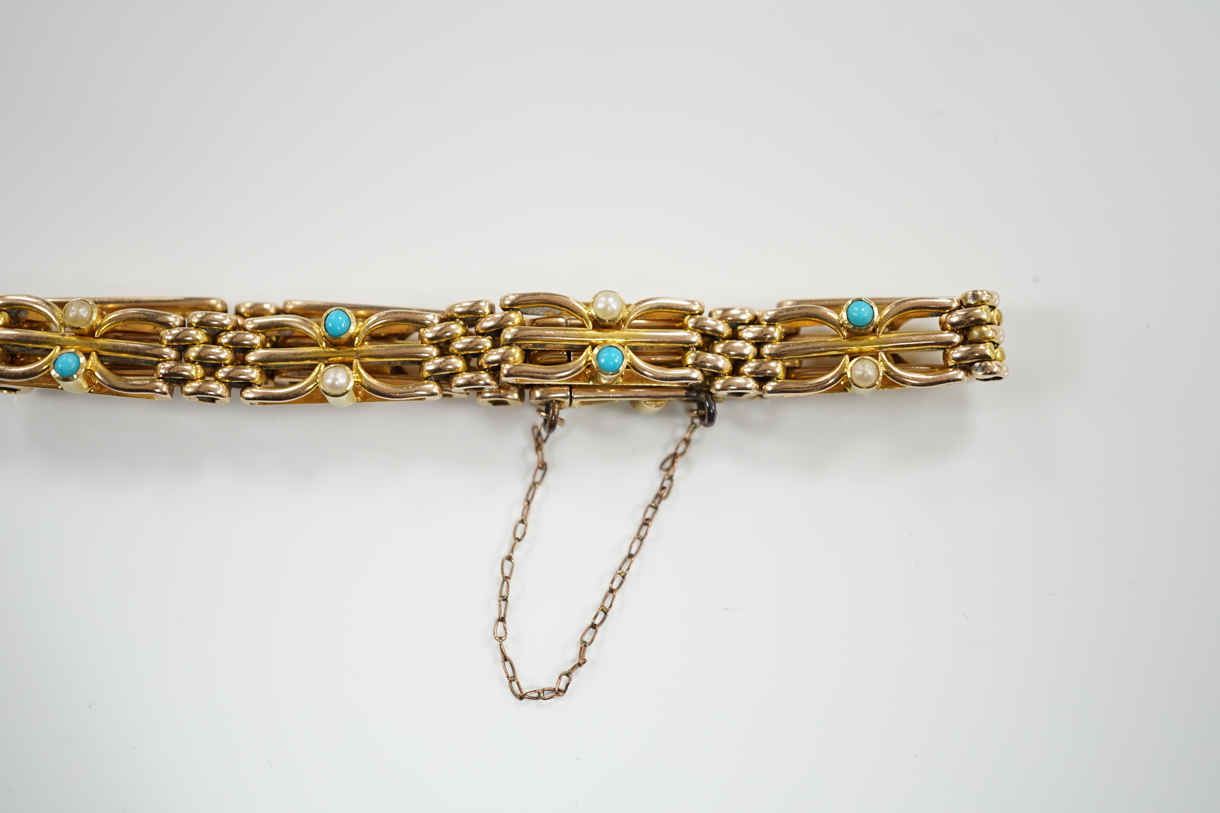 An Edwardian 15ct, turquoise and seed pearl set gate link bracelet, 18cm, gross weight 16.7 grams.